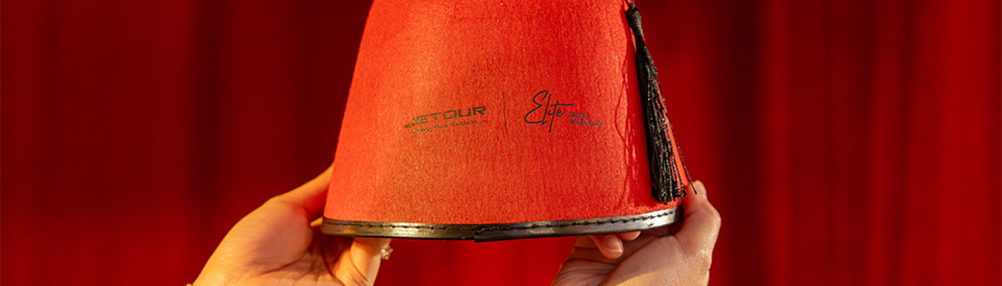 Jetour Ramadan event gift with branded traditional red fez.